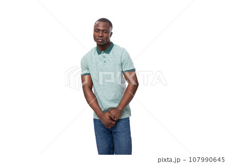 young charming american guy dressed in a mint t-shirt and jeans on a white background with copy young charming american guy dressed in a mint t-shirt and jeans on a white background with copy 107990645