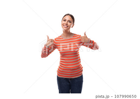 Young smart slim brunette woman dressed in a striped orange blouse and jeans on a white background 107990650