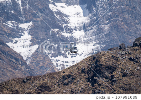 Helicopter Flying in the Mountains 107991089