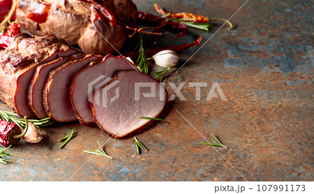 Smoked ham with rosemary, garlic, and red pepper. 107991173