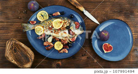 Baked sea bream dorada fish with figs. 107991494