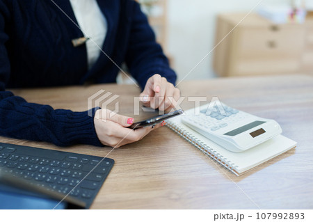 financial, Planning, Marketing and Accounting, portrait of Asian employee checking financial statements using and calculator, tablet computer and smart phone at work. financial, Planning, Marketing and Accounting, portrait of Asian employee checking financial statements using and calculator, tablet computer and smart phone at work. 107992893