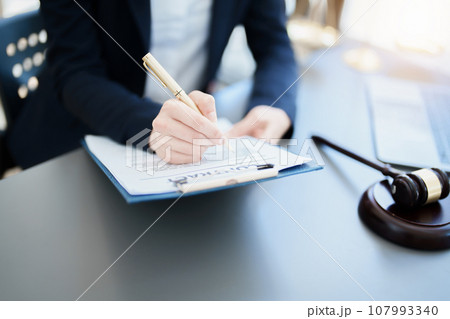 Portrait of a Asian woman lawyer studying a lawsuit for a client before going to court. Portrait of a Asian woman lawyer studying a lawsuit for a client before going to court. 107993340