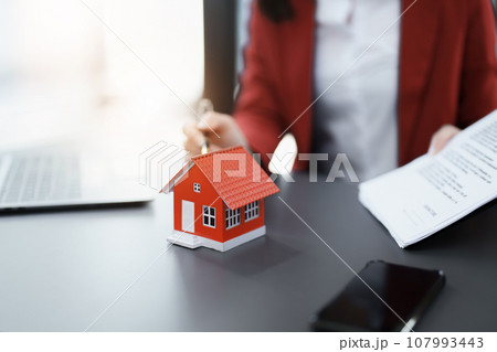 Guarantee, mortgage, agreement, contract, signed, real estate agent pointing to documents for customers to read the agreement before signing important documents. 107993443