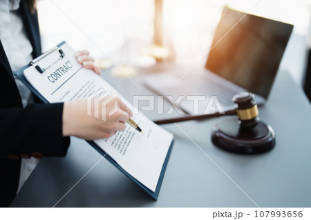 The lawyer with a client discussing contract paper, a Business lawyer working about legal legislation in the courtroom to help their customer, contract and agreement concept 107993656