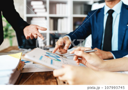 Asian business advisor meeting to analyze and discuss the situation on the financial report in the meeting room.Investment Consultant, Financial , teamwork ,brainstorming ,startup and accounting. 107993745
