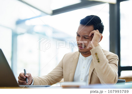 Portrait of sme business owner, man using computer and financial statements Anxious expression on expanding the market to increase the ability to invest in business. Portrait of sme business owner, man using computer and financial statements Anxious expression on expanding the market to increase the ability to invest in business. 107993789