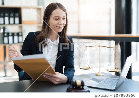 Portrait of a Asian woman lawyer studying a lawsuit for a client before going to court 107993860