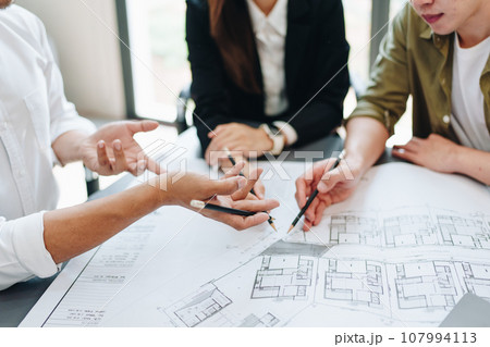 Engineers, designers and interior designers are finalizing the design of interiors by discussing selecting materials and colors to design rooms to present to clients 107994113