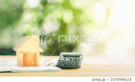 House placed on table. notebook and pen Prepare planning savings money of coins to buy a home concept for property ladder, mortgage and real estate investment. House placed on table. notebook and pen Prepare planning savings money of coins to buy a home concept for property ladder, mortgage and real estate investment. 107996628