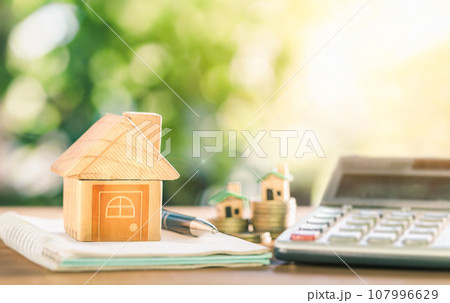 House placed on coins. notebook and pen Prepare planning savings money of coins to buy a home concept for property ladder, mortgage and real estate investment. House placed on coins. notebook and pen Prepare planning savings money of coins to buy a home concept for property ladder, mortgage and real estate investment. 107996629