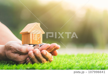Home loan, home insurance, family life assurance protection, financial mortgage for house building, and legacy planning investment concept with children - parent's hands holding private property 107996641