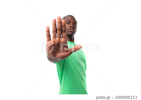 portrait of young smart african man dressed in green t-shirt and jeans isolated on white background 108000151