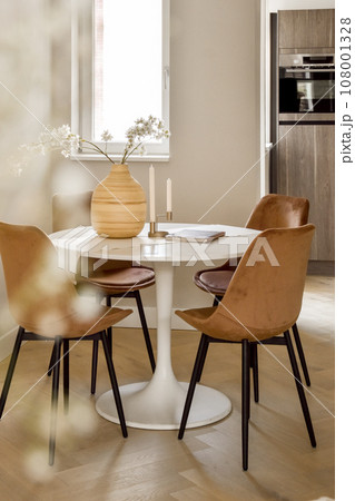 a dining room with chairs and a table in front of the window, there is a vase on the table a dining room with chairs and a table in front of the window, there is a vase on the table 108001328