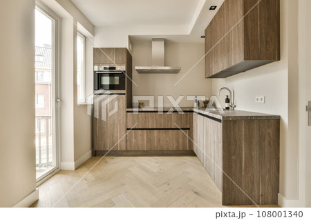 a modern kitchen with wood cabinets and white marble countertops in the room is very clean, but it's not too 108001340