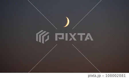 A young moon in a dark sky. A young moon in a dark sky. 108002081