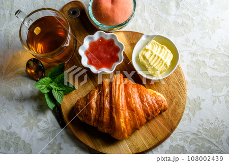 Croissant with tea and jam for breakfast Croissant with tea and jam for breakfast 108002439