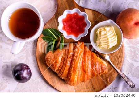 Croissant with tea and jam for breakfast Croissant with tea and jam for breakfast 108002440