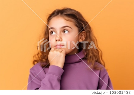 Cute girl looking at copy space touching chin hand thinking isolated pastel color background 108003458