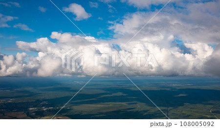 View of a large white cloud from an airplane window 108005092