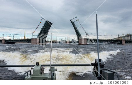 The divorced Palace Bridge across the Neva River in St. Petersburg on a cloudy summer day. 108005093