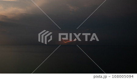 Lightning over the sea during a thunderstorm on a summer night Lightning over the sea during a thunderstorm on a summer night 108005094