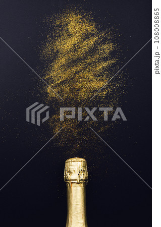 Champagne bottle with glitter on black background 108008865