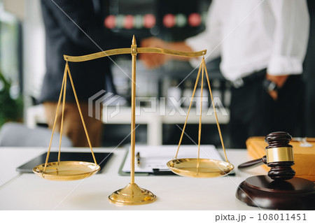 Male lawyer in the office with brass scale on wooden table. justice and law concept . 108011451