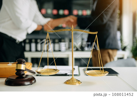 Male lawyer in the office with brass scale on wooden table. justice and law concept . 108011452