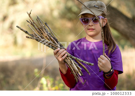 Child's Curiosity with Nature's Twigs Child's Curiosity with Nature's Twigs 108012333