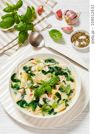 chicken spinach artichoke creamy soup in a bowl chicken spinach artichoke creamy soup in a bowl 108012632