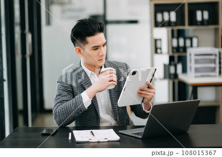 Mature business man executive manager looking at laptop watching online webinar training or having virtual meeting video conference doing market research working in office.. Mature business man executive manager looking at laptop watching online webinar training or having virtual meeting video conference doing market research working in office.. 108015367