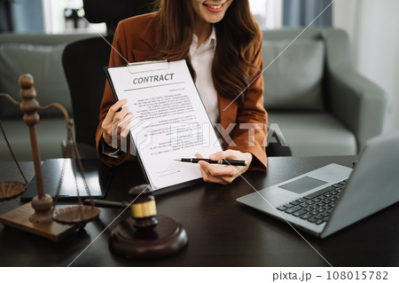 justice and law concept.Male judge in a courtroom on wooden table and Counselor or Male lawyer working in modern office. . justice and law concept.Male judge in a courtroom on wooden table and Counselor or Male lawyer working in modern office. . 108015782