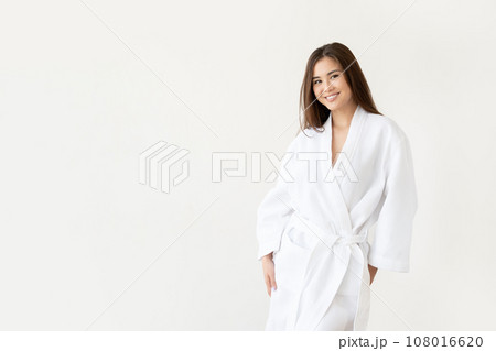 Beautiful Asian woman in white robe on white background with copy space 108016620