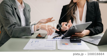 Businessman and team analyzing financial statement Finance task. with smart phone and laptop and  tablet. Wealth management concept.. 108016664