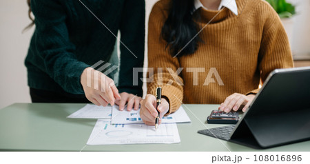 Businessman and team analyzing financial statement Finance task. with smart phone and laptop and  tablet. Wealth management concept.. 108016896