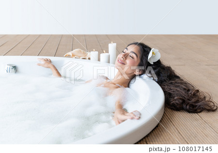 Beautiful indian woman enjoying round bath full of foam Beautiful indian woman enjoying round bath full of foam 108017145