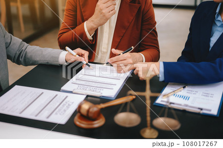 Business people compassionately holding hands and discussing contract papers with laptop and tabletat office room.. 108017267