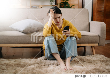 woman sit Depression Dark haired pensive glance Standing by window and anxiety Copy space. at home woman sit Depression Dark haired pensive glance Standing by window and anxiety Copy space. at home 108017506