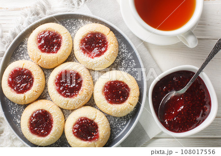 Hallongrottor or Swedish rapsberry caves jam cookies closeup on the plate. Horizontal top view Hallongrottor or Swedish rapsberry caves jam cookies closeup on the plate. Horizontal top view 108017556