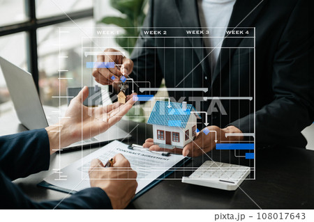 Real estate broker agent presenting and consult to customer to decision making sign insurance form agreement, home model, concerning mortgage loan offer 108017643