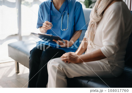 Female doctor filling up an application form while consulting patient. Medicine and health care concept. Medicine Female doctor filling up an application form while consulting patient. Medicine and health care concept. Medicine 108017760