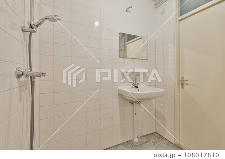 a bathroom with a sink and mirror on the wall next to the shower stall in the photo is taken from above a bathroom with a sink and mirror on the wall next to the shower stall in the photo is taken from above 108017810