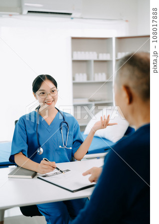 Serious Asia female doctor using clipboard is delivering great news talk discuss results or symptoms with female patient in clinic or hospital . 108017888