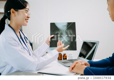 Serious Asia female doctor using clipboard is delivering great news talk discuss results or symptoms with female patient in clinic or hospital . Serious Asia female doctor using clipboard is delivering great news talk discuss results or symptoms with female patient in clinic or hospital . 108017938