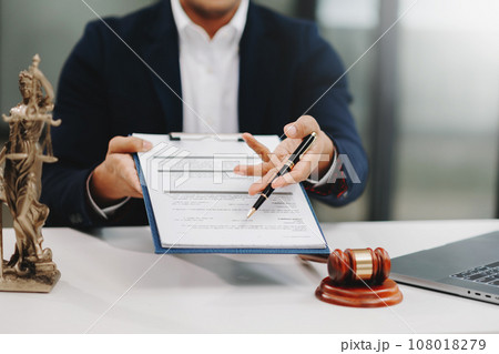 justice and law concept.Male judge in a courtroom on wooden table and Counselor or Male lawyer working in office. . justice and law concept.Male judge in a courtroom on wooden table and Counselor or Male lawyer working in office. . 108018279