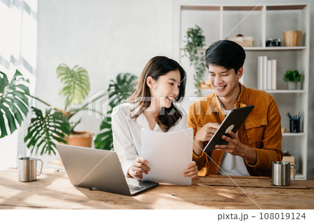 Portrait of success Asian business people working together in home office. Couple teamwork startup concept.. 108019124