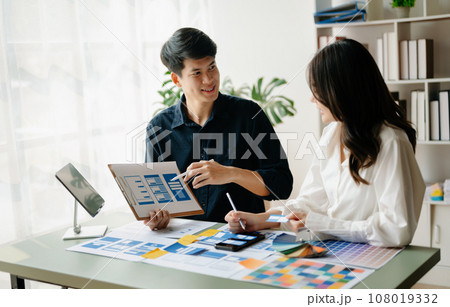 Asian businessman and woman people meeting in office. Employee brainstorm and work as team, plan and discuss project by point on paper and tablet. . Asian businessman and woman people meeting in office. Employee brainstorm and work as team, plan and discuss project by point on paper and tablet. . 108019332