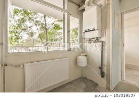 a bathroom with a toilet in the corner and a window that looks out onto the street, as seen from inside a bathroom with a toilet in the corner and a window that looks out onto the street, as seen from inside 108019807