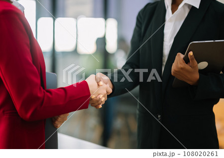 business people shaking hands during a meeting in office 108020261
